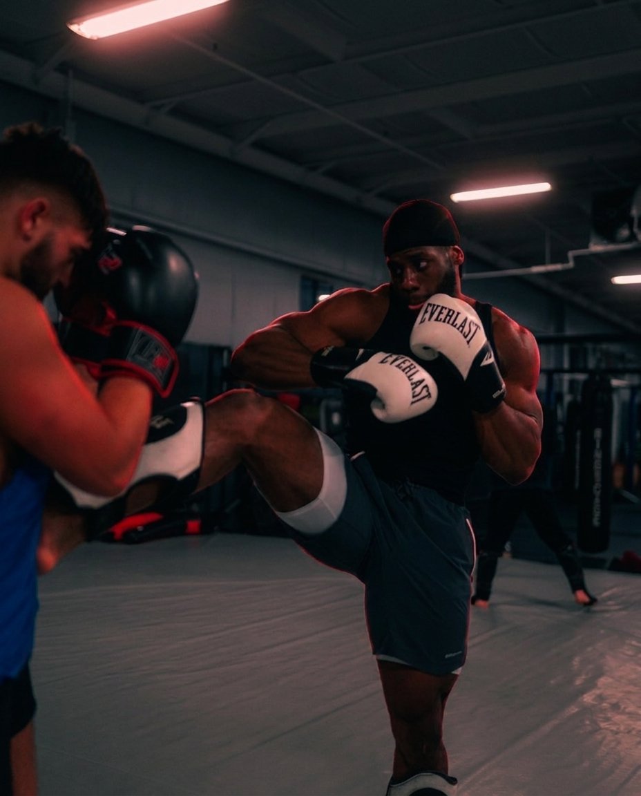 Athlete driving a knee into pads under pressure