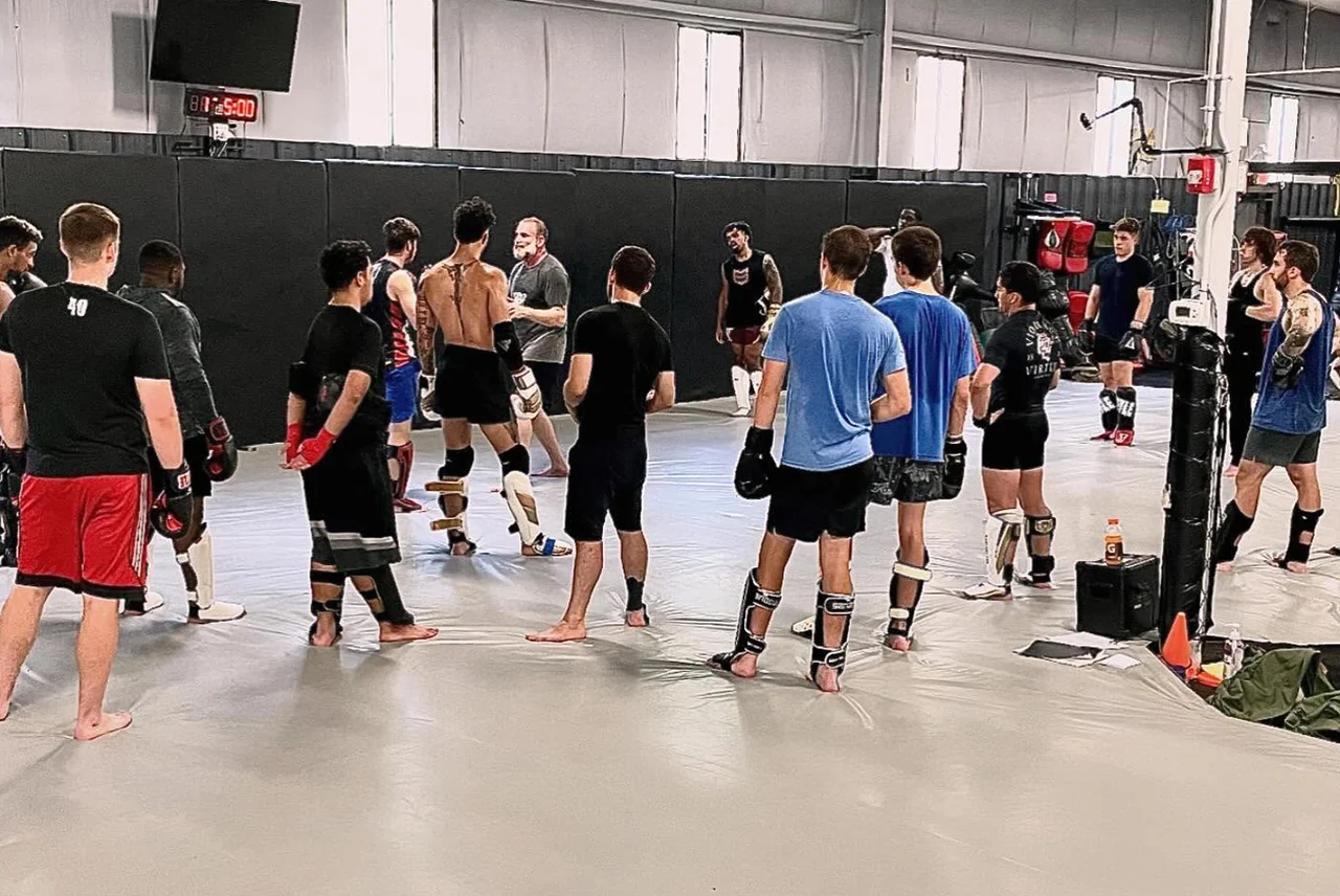 Students gathering for instruction on the mat