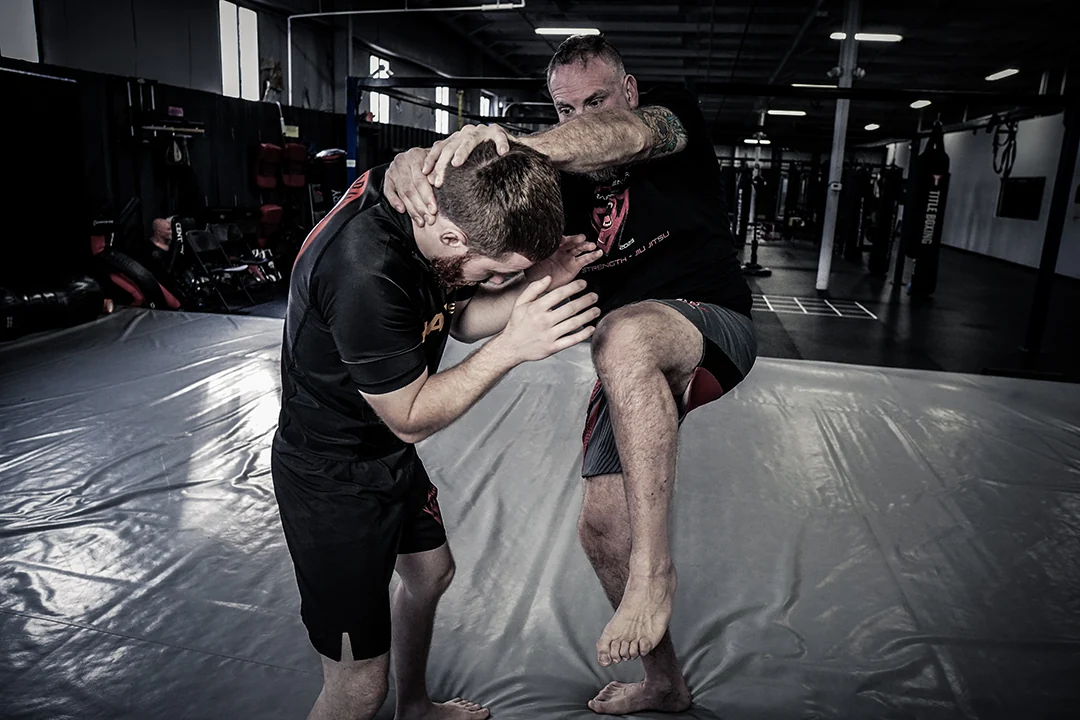 Partner practice connecting a clinch and a knee