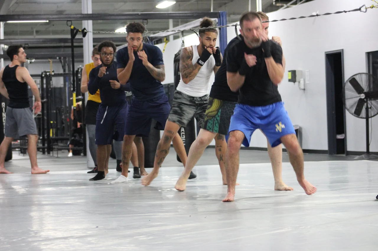 A group practicing boxing footwork