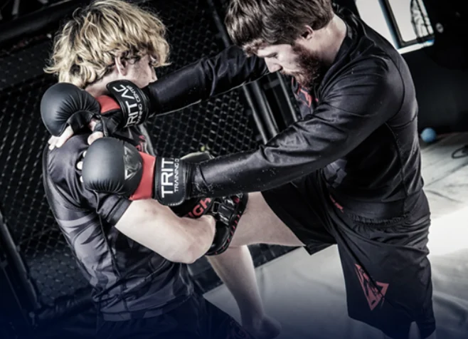TRITAC partners practicing a clinch and knee
