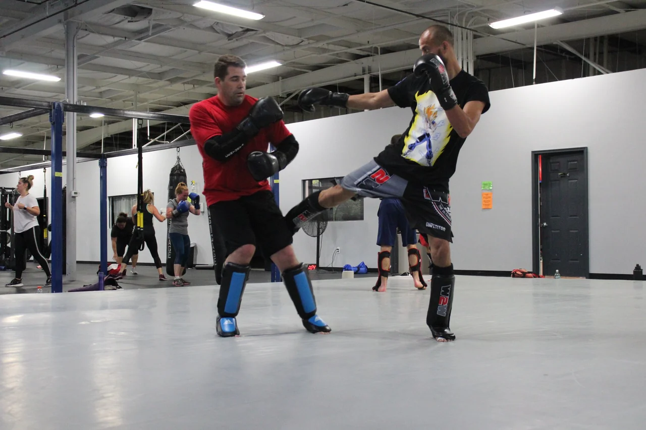 Two training partners working kicks and defense