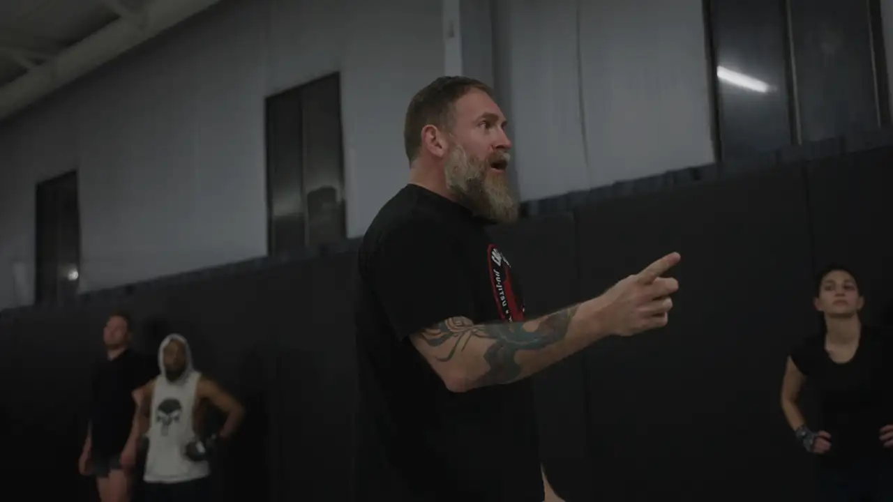 Matt teaching, pointing to a student