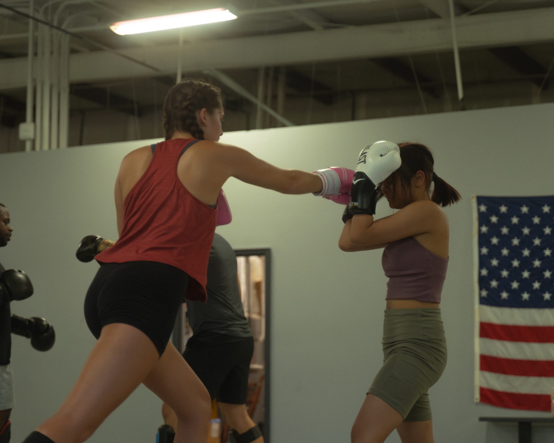 A live striking exchange in class, one partner landing a straight punch