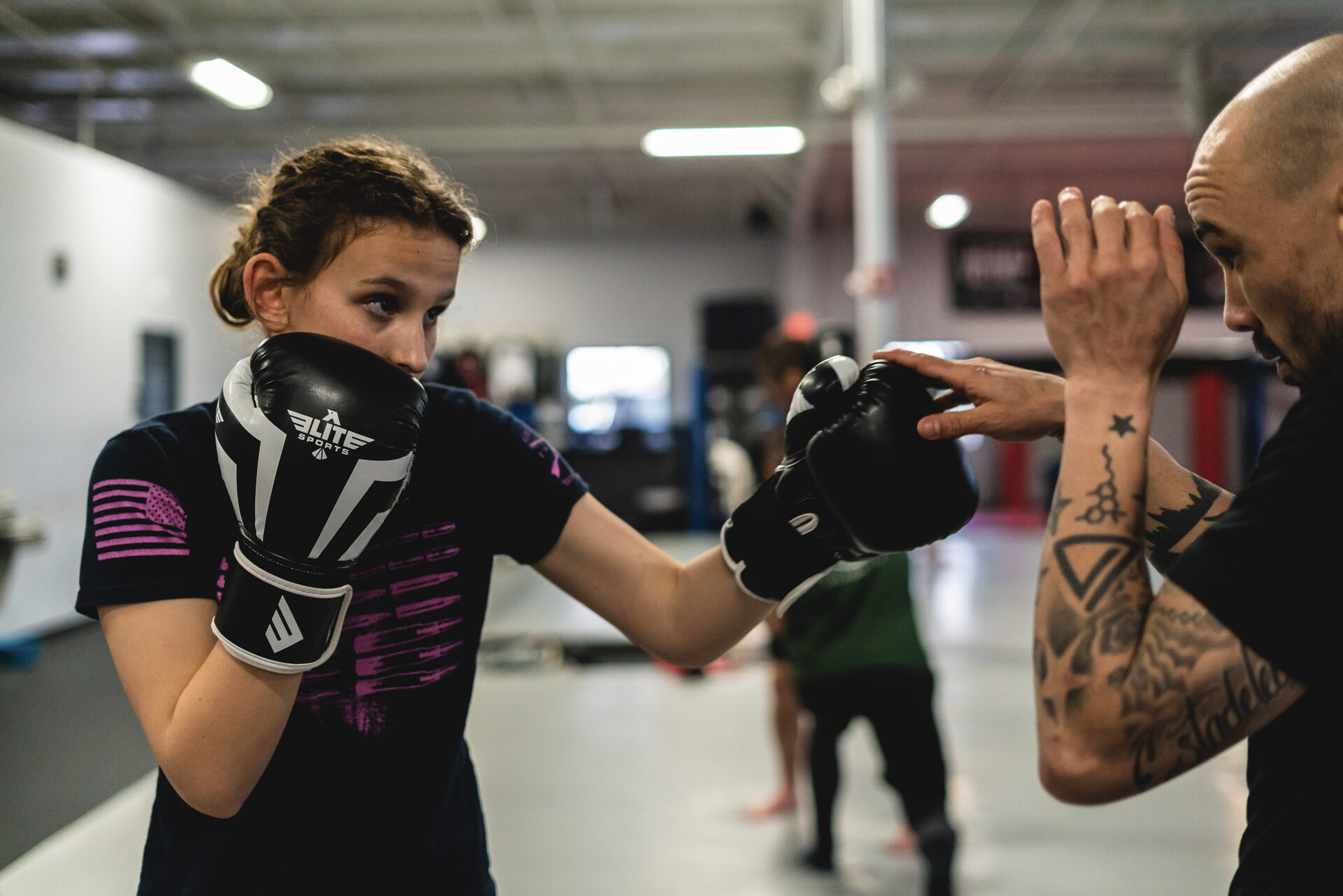 A member with hands up mid-exchange as the coach's glove comes in