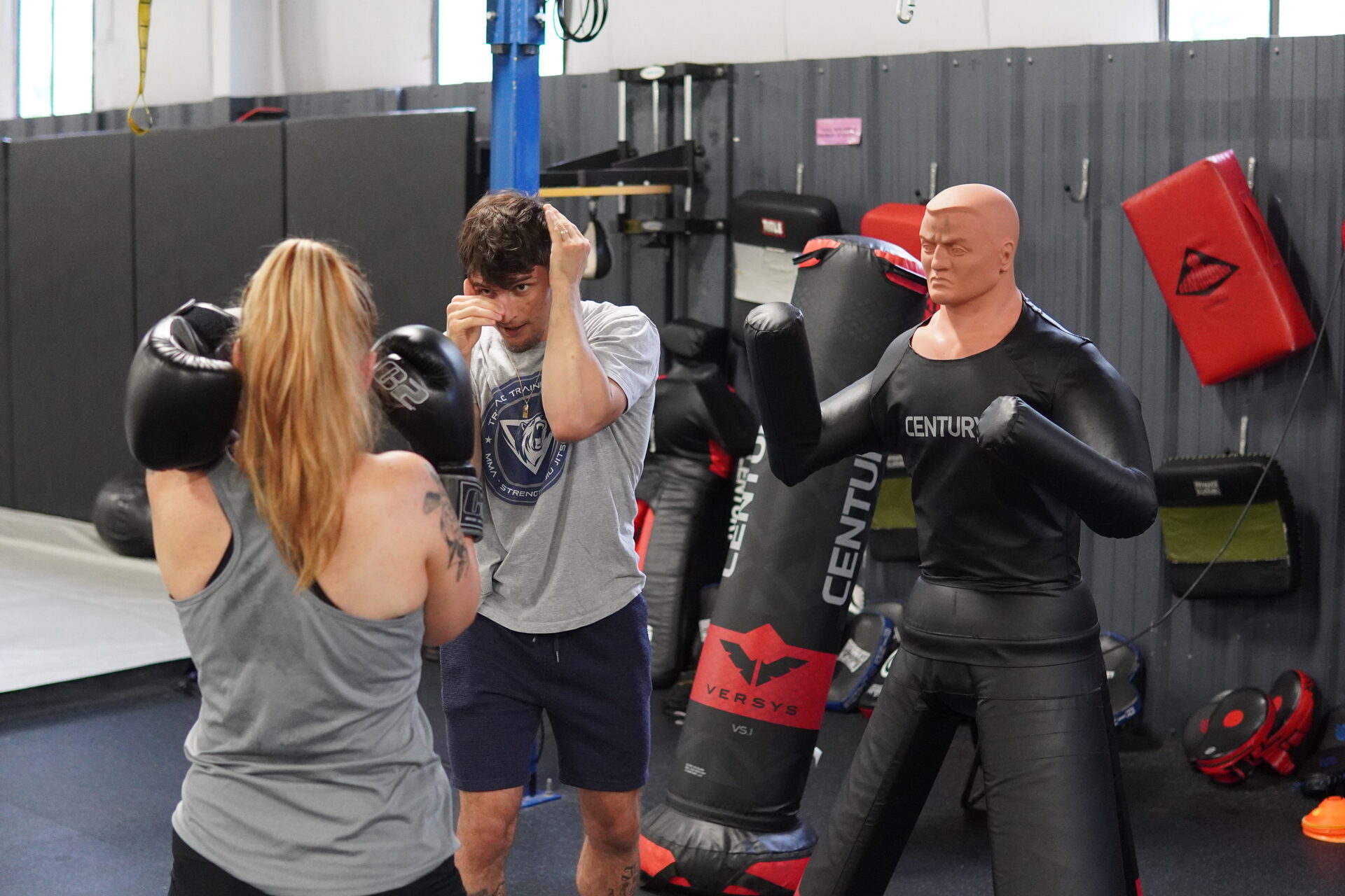 Two members in gloves working beside the BOB striking dummies